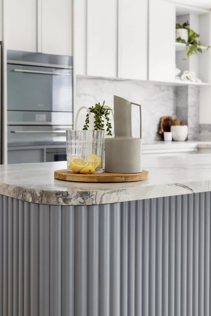 A styled jug and glass set on the bench of a newly completed northern beaches kitchen renovation.