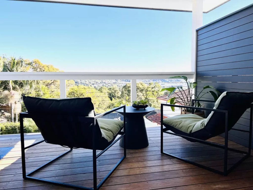 outdoor chairs on a deck with a district view.