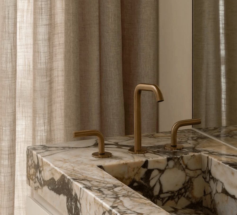 Bronze tapware on marbled basin