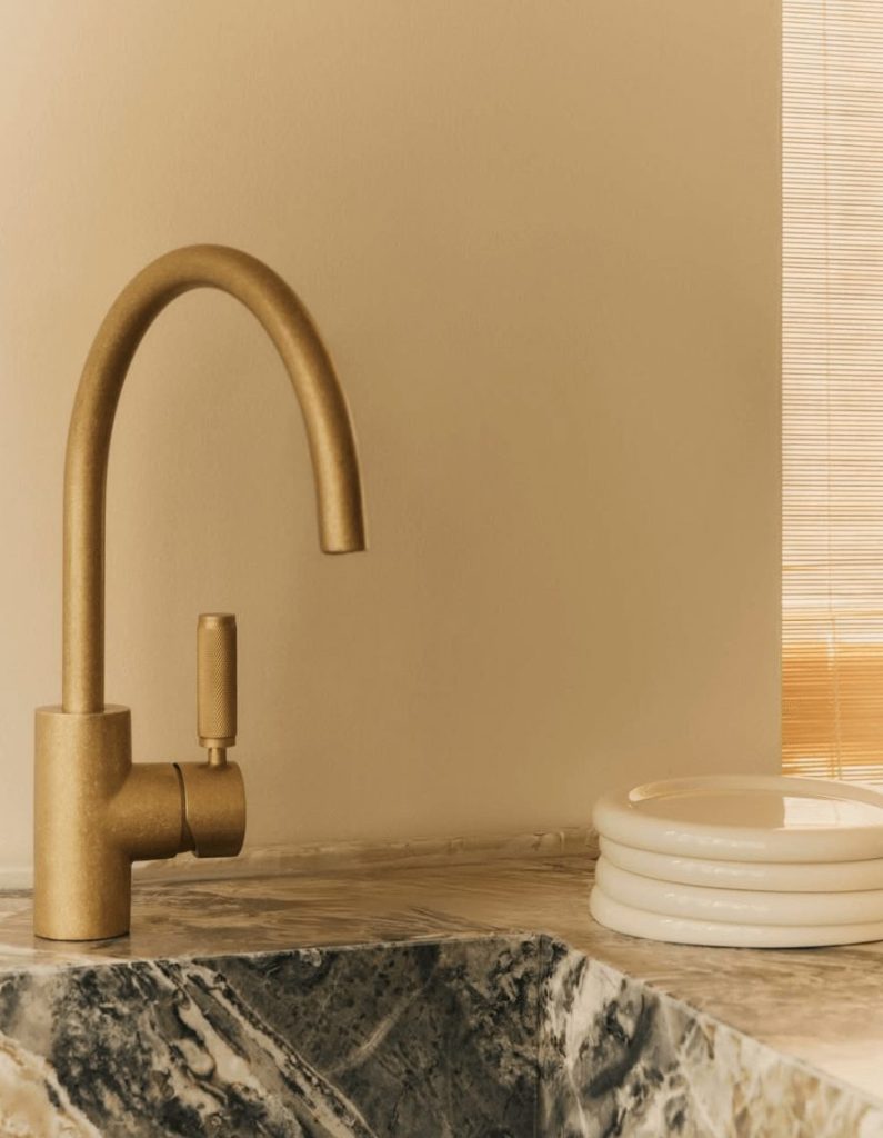 Tumble finished tapware on marbled sink
