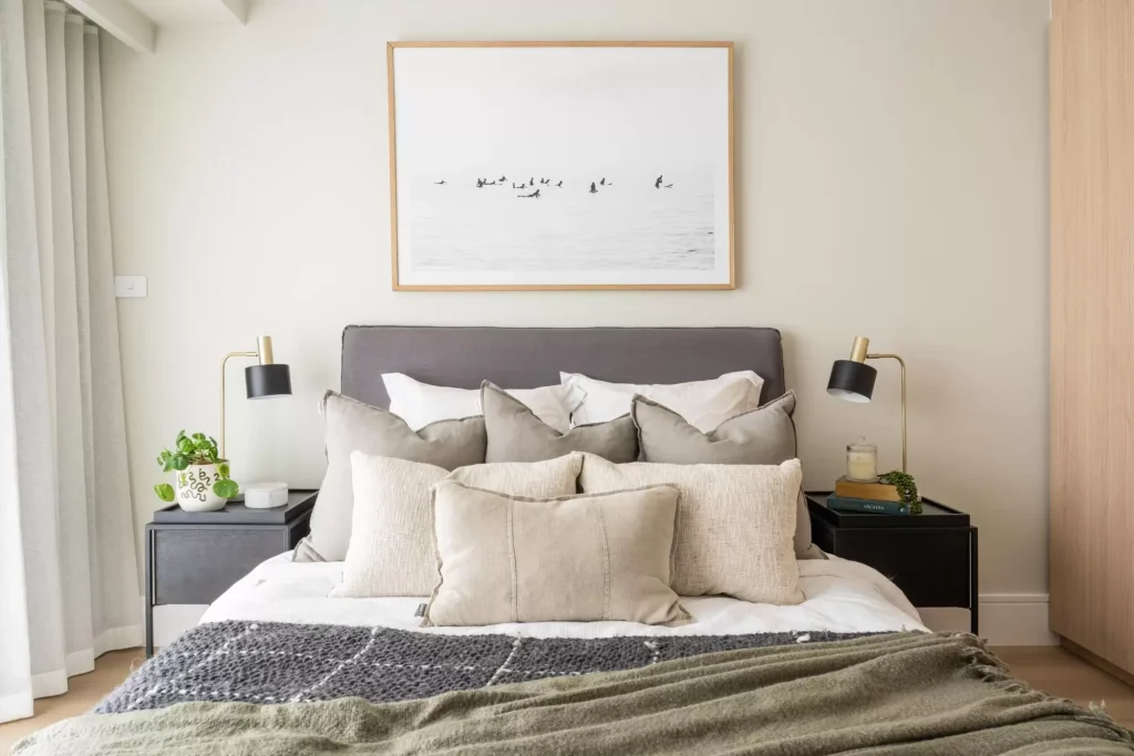 soft furnishings styled on a bed in a full apartment renovation in Manly, Sydney