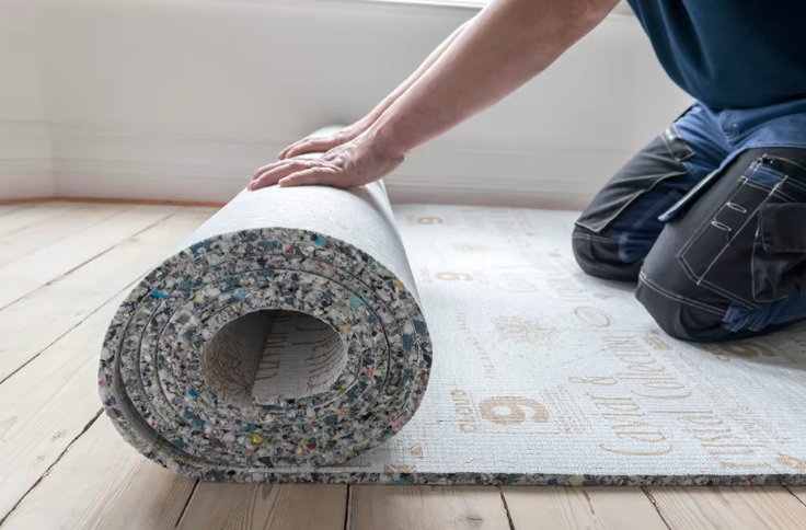rolling out flooring underlay