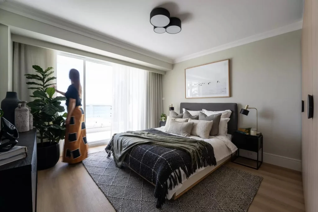 woman adjusting the curtains in bedroom in Manly NSW