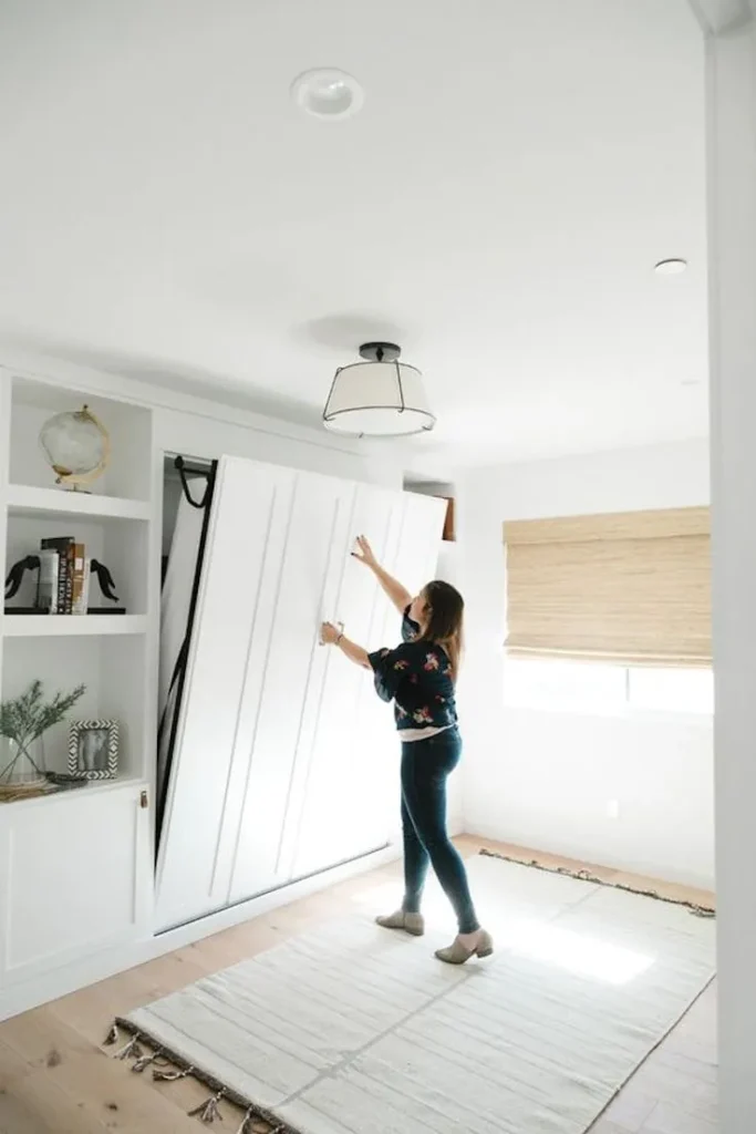 woman pulling down a murphy bed
