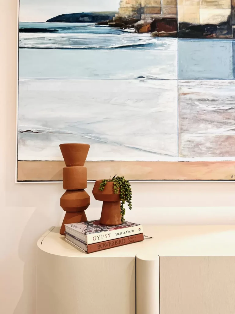 ocean artwork and terracotta vases