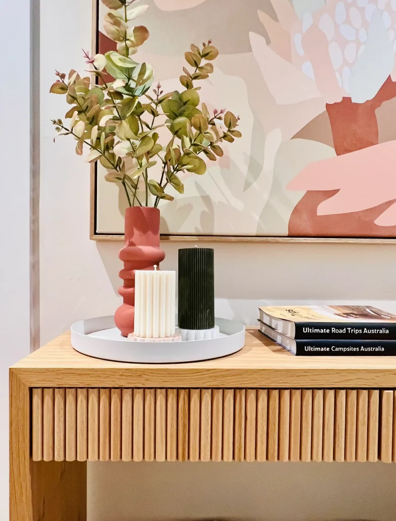 pink and terracotta toned paining and styled console