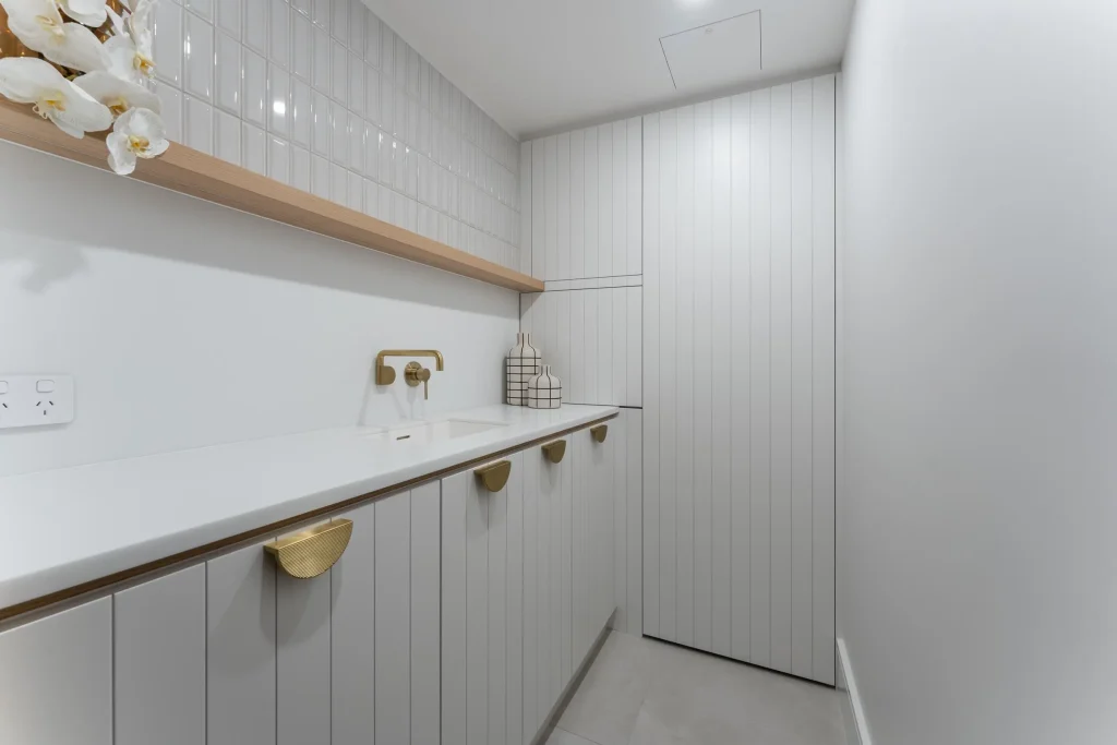 Small space laundry design in Manly apartment